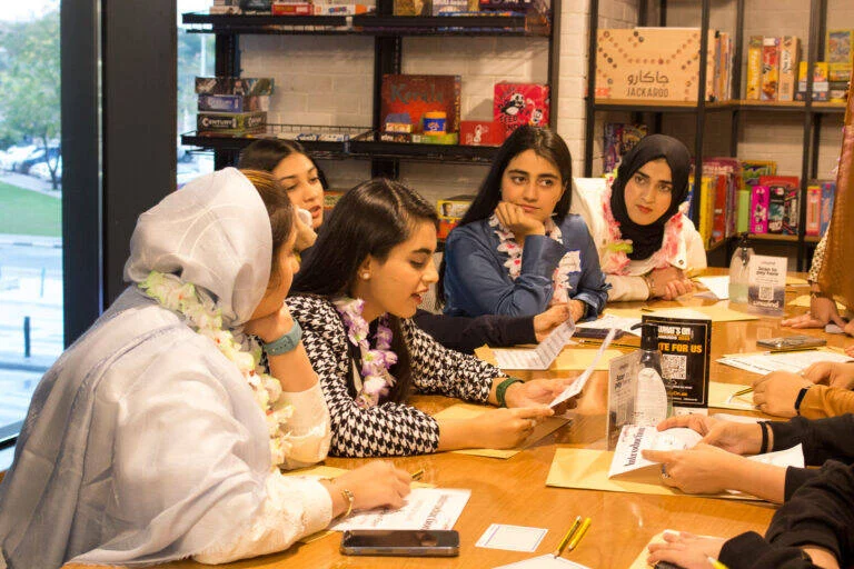 A group learning a board game with an Unwind Game Master