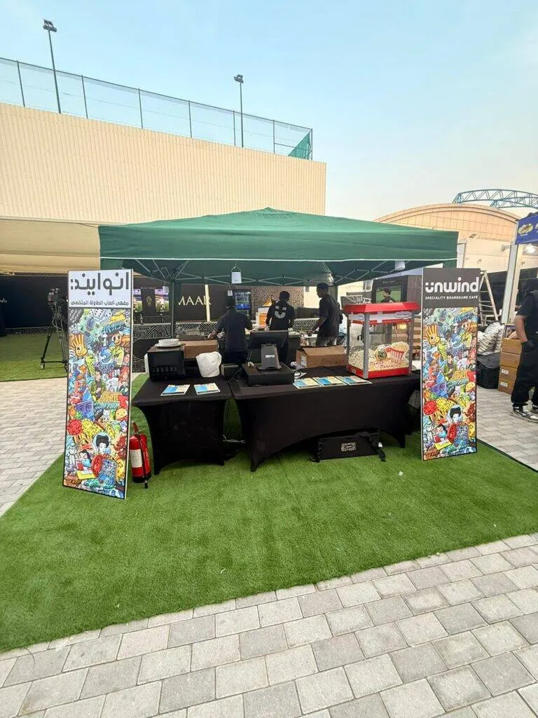 The Unwind team serving guests at an outdoor event stall