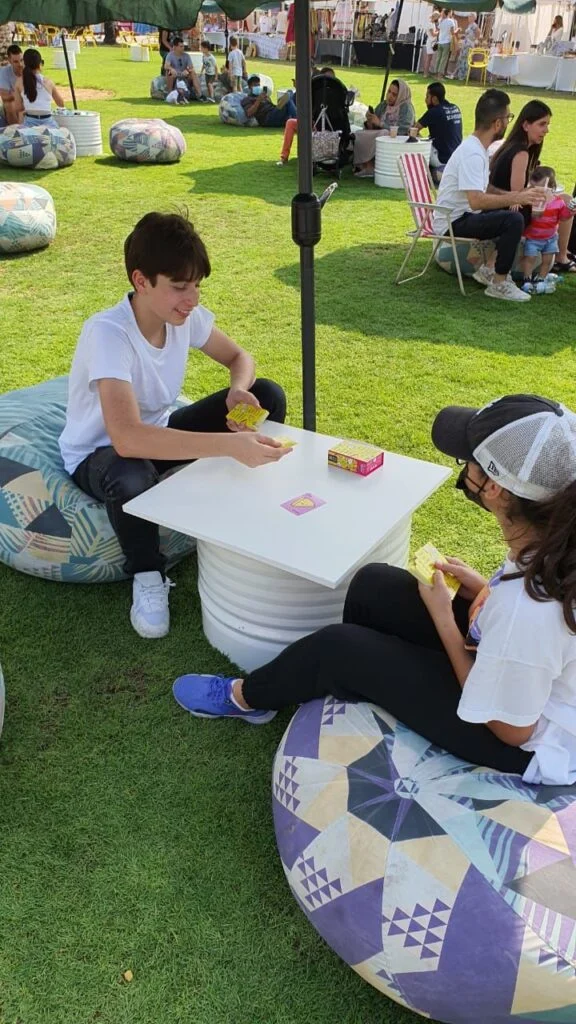 Children playing board games on beanbags at an Unwind game zone