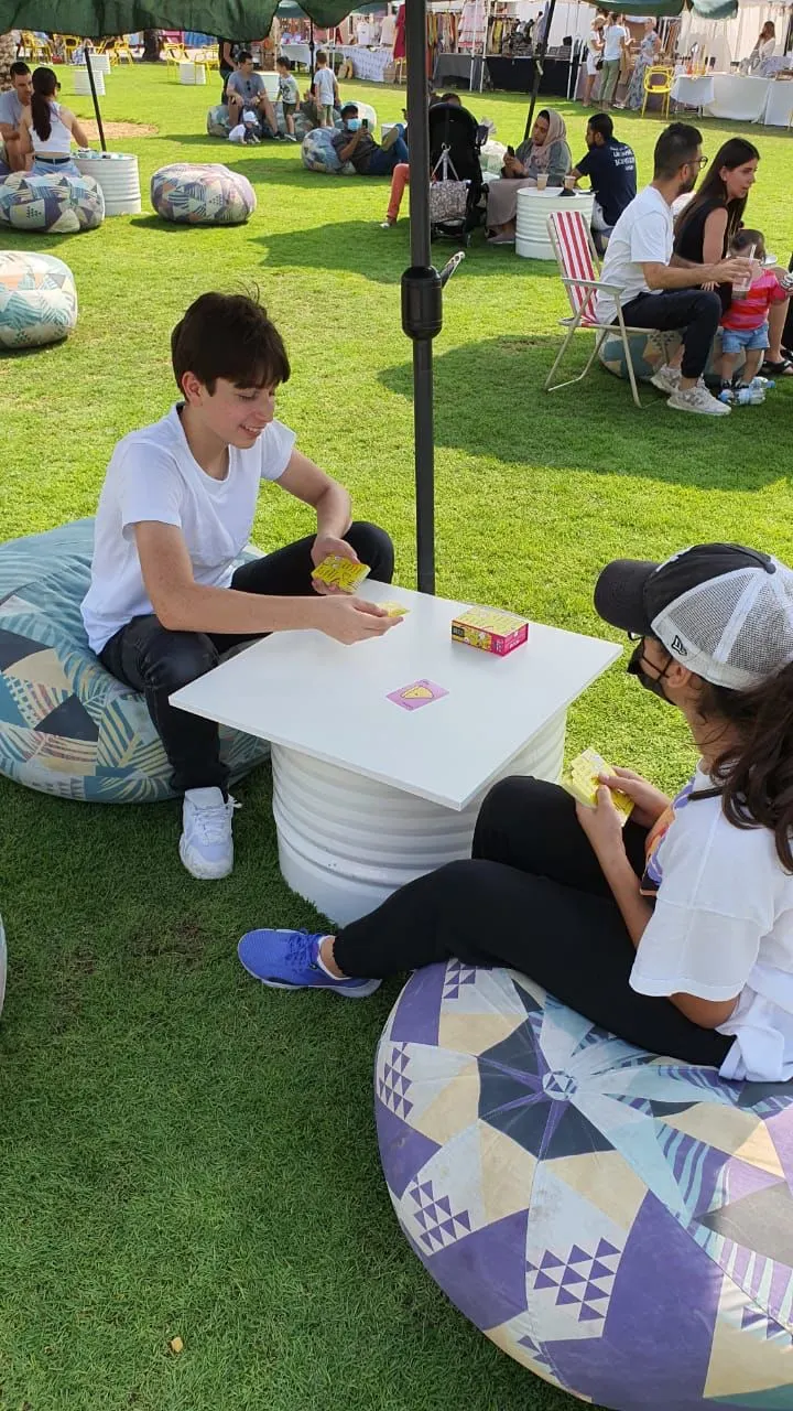 Children playing board games on beanbags at an Unwind game zone